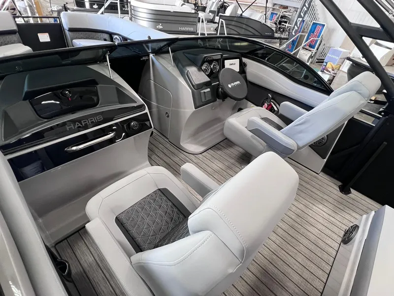 Slide: The Image of 2025 Harris Solstice DC 250 boat interior with modern helm and seating. - 8