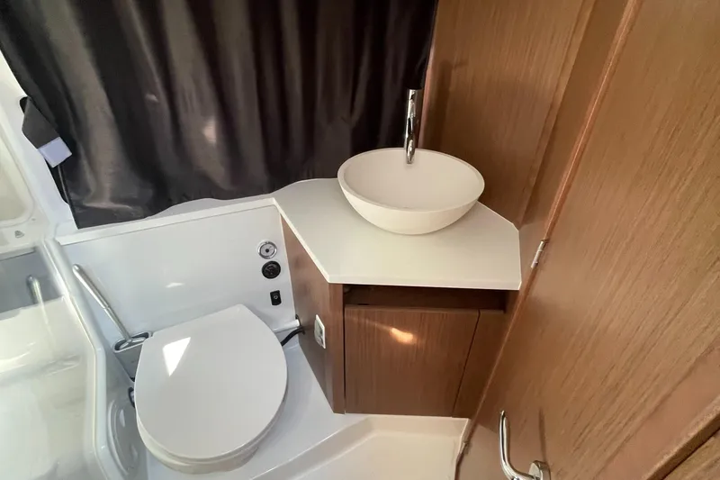 Slide: The Image of Modern bathroom in 2022 Beneteau Antares 11 with sleek sink and toilet. - 12