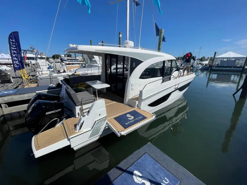 Slide: The Image of 2022 Beneteau Antares 11 boat docked at marina under clear blue sky. - 14