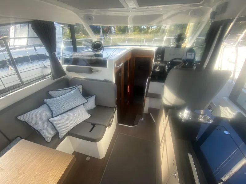 Slide: The Image of Interior of 2022 Beneteau Antares 11 boat with seating and helm station. - 21