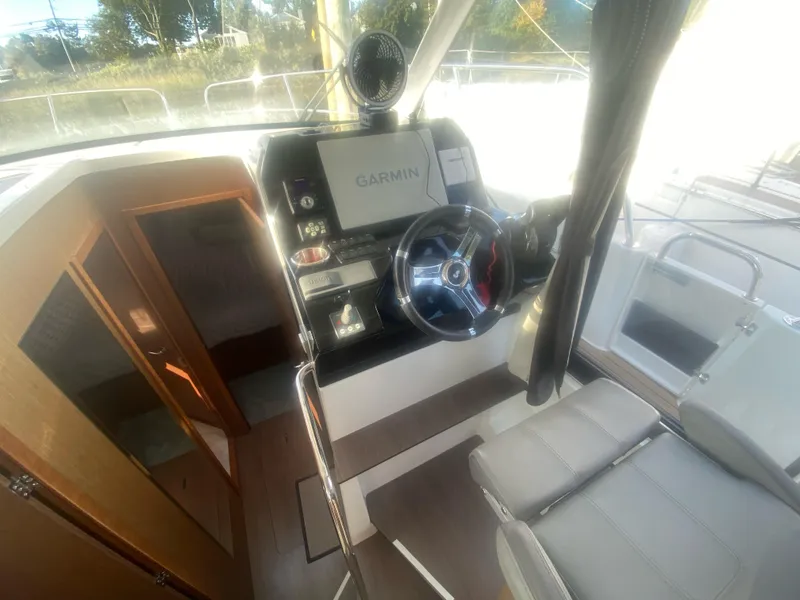 Slide: The Image of Interior view of 2022 Beneteau Antares 11 boat cockpit with Garmin navigation system. - 22