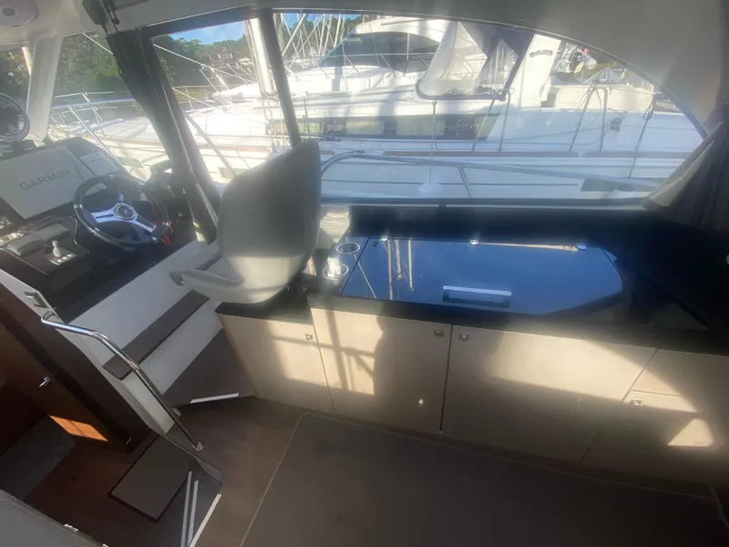 Slide: The Image of Interior of 2022 Beneteau Antares 11 yacht with helm and kitchenette. - 23