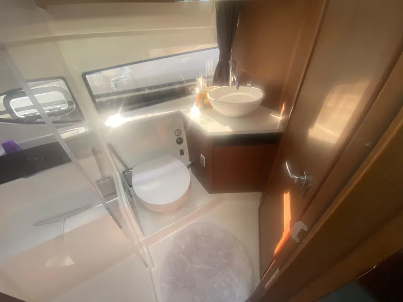 Slide: The Image of Interior of 2022 Beneteau Antares 11 bathroom with modern fixtures and natural lighting. - 24