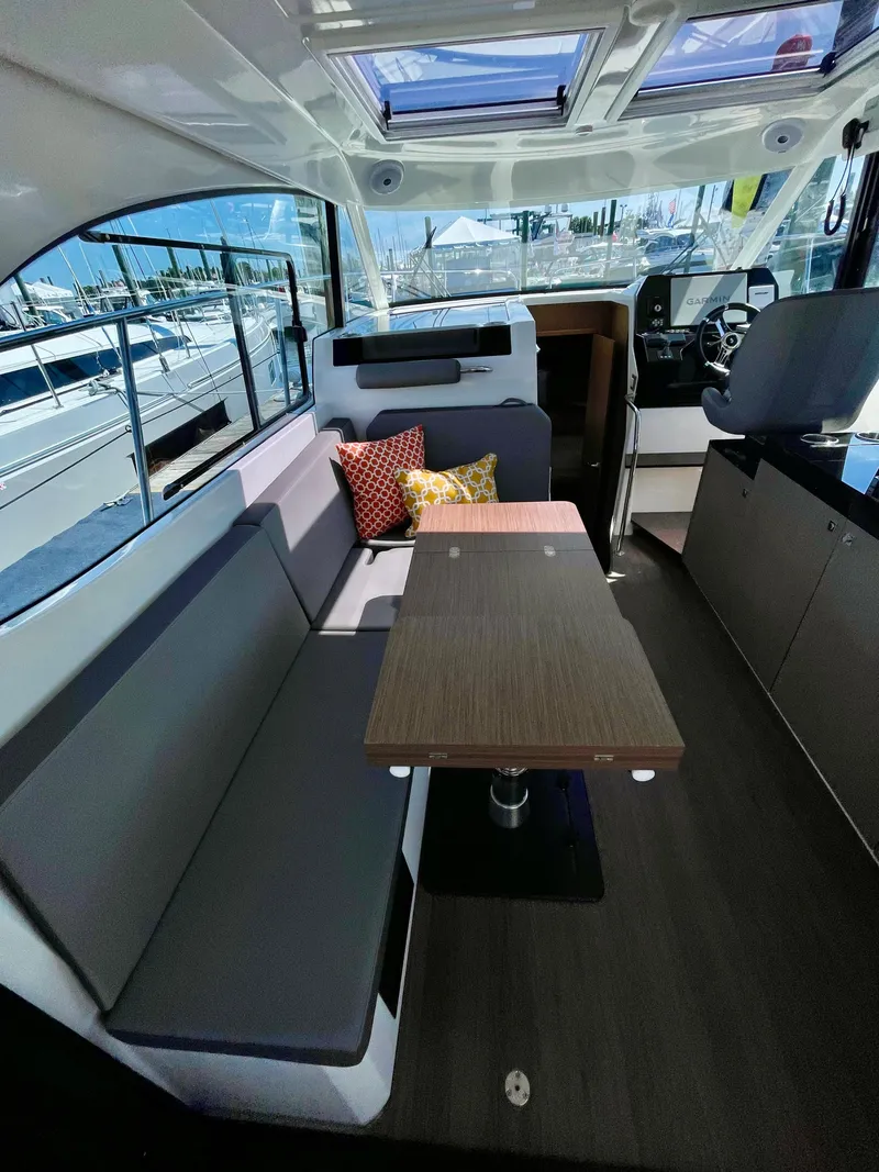 Slide: The Image of Interior of 2022 Beneteau Antares 11 with seating and table, showcasing modern design. - 4