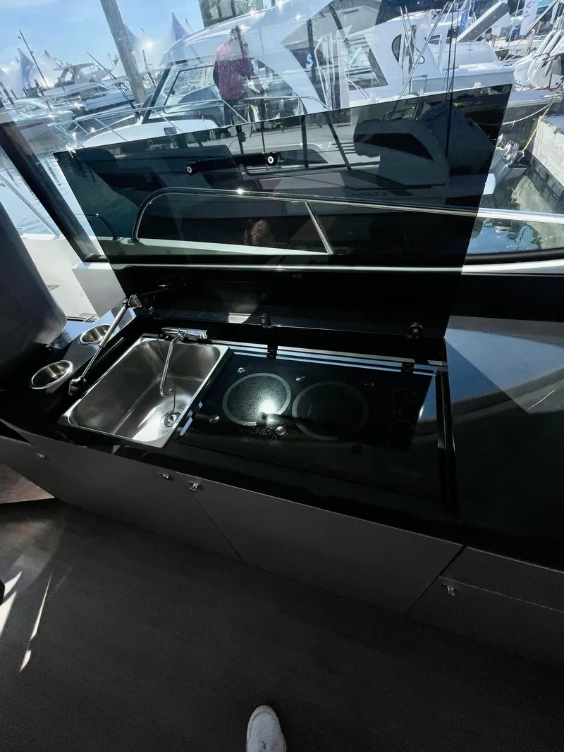 Slide: The Image of Modern kitchen in 2022 Beneteau Antares 11 yacht with sleek black countertops. - 6