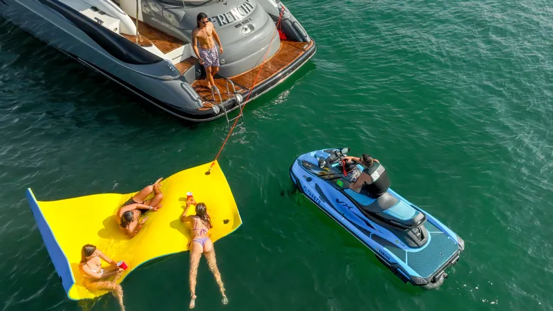 Slide: The Image of People relaxing near a 1999 Sunseeker Predator 58 yacht with a jet ski. - 10