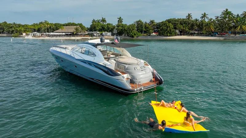 Slide: The Image of Sunseeker Predator 58 yacht anchored near tropical beach, people relaxing on floating mat. - 2