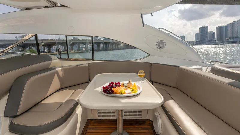 Slide: The Image of Luxurious Sunseeker Predator 58 yacht interior with fruit platter and wine, overlooking cityscape. - 25