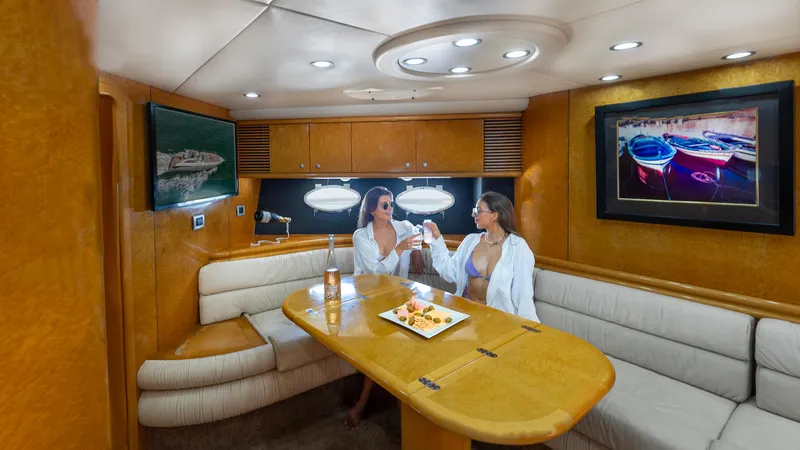 Slide: The Image of Luxurious Sunseeker Predator 58 yacht interior with two women enjoying drinks, 1999 model. - 26
