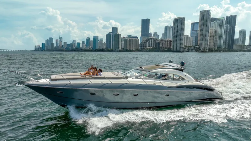 Slide: The Image of Sunseeker Predator 58 yacht cruising near city skyline, 1999 model. - 3