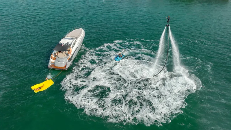 Slide: The Image of Sunseeker Predator 58 yacht with flyboarder in action on open water, 1999 model. - 38