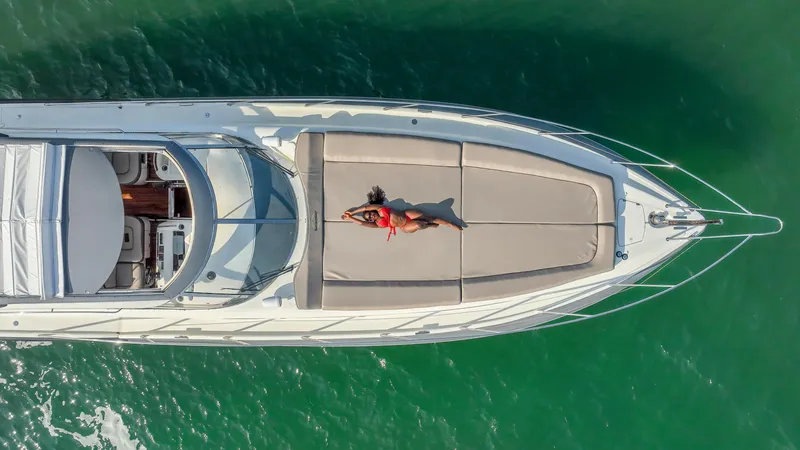 Slide: The Image of Aerial view of 1999 Sunseeker Predator 58 yacht with person sunbathing on deck. - 44