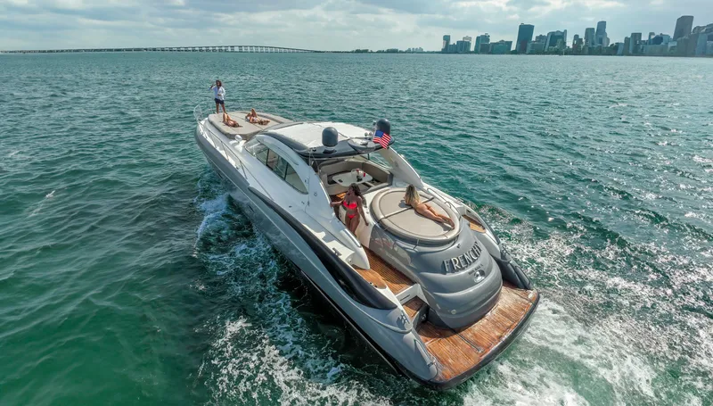 Slide: The Image of Luxurious 1999 Sunseeker Predator 58 yacht cruising near city skyline. - 45