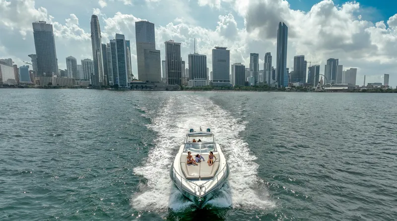 Slide: The Image of Sunseeker Predator 58 yacht cruising near city skyline, 1999 model. - 47