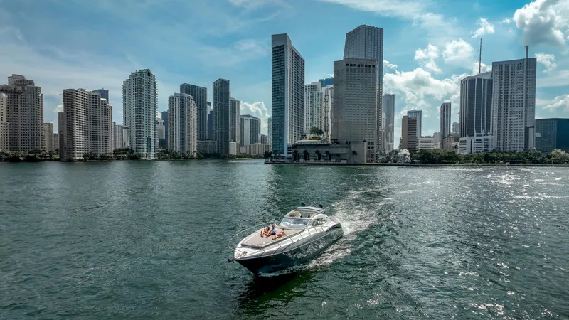 Slide: The Image of Sunseeker Predator 58 yacht cruising near city skyline, 1999 model. - 48