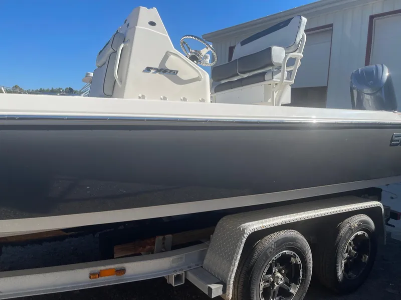 The Image of 2025 Skeeter SX221 boat on trailer, side view, outdoors, clear sky. - 0