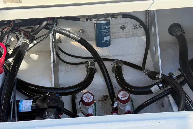 Slide: The Image of 2025 Skeeter SX221 boat engine compartment with hoses and fuel filter system. - 14
