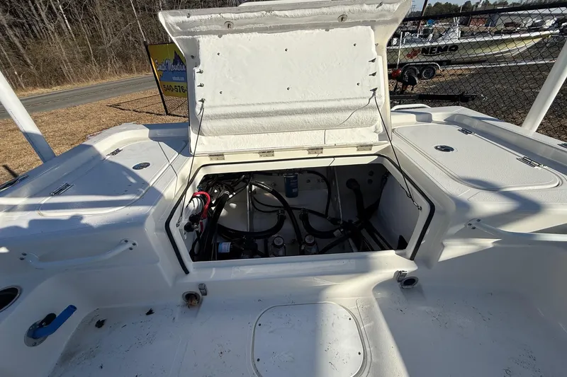 Slide: The Image of 2025 Skeeter SX221 boat with open storage compartment, showcasing internal wiring and components. - 15