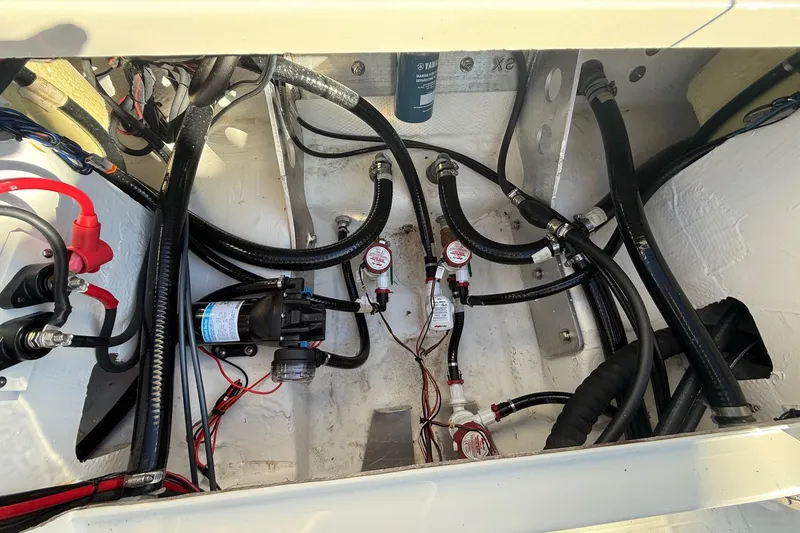 Slide: The Image of 2025 Skeeter SX221 boat interior showing wiring and plumbing components. - 16