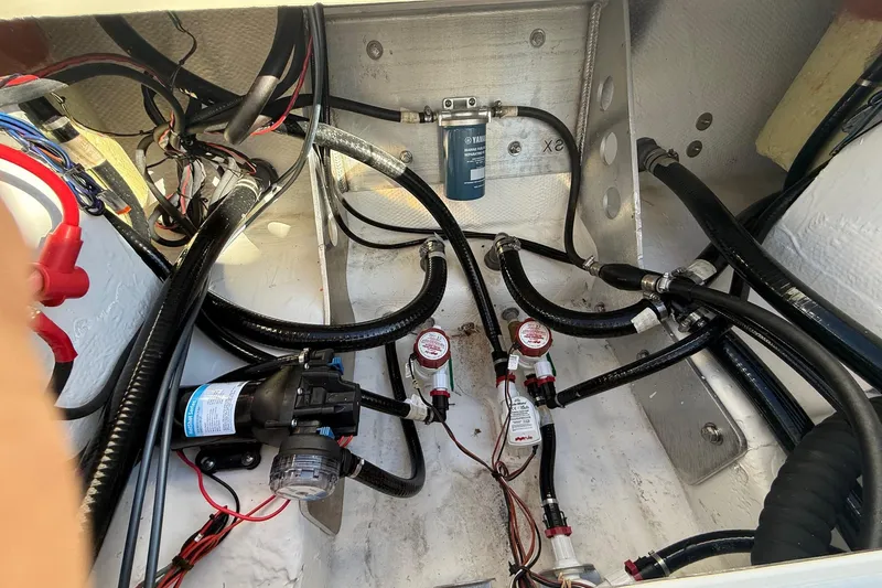 Slide: The Image of 2025 Skeeter SX221 boat wiring and plumbing system in the engine compartment. - 17