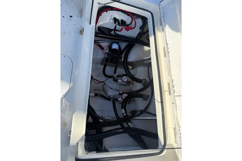 Slide: The Image of 2025 Skeeter SX221 boat compartment with wiring and plumbing components. - 18