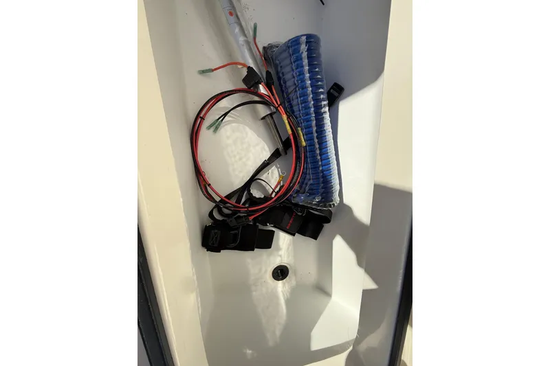 Slide: The Image of 2025 Skeeter SX221 boat compartment with wiring and coiled tubing. - 32