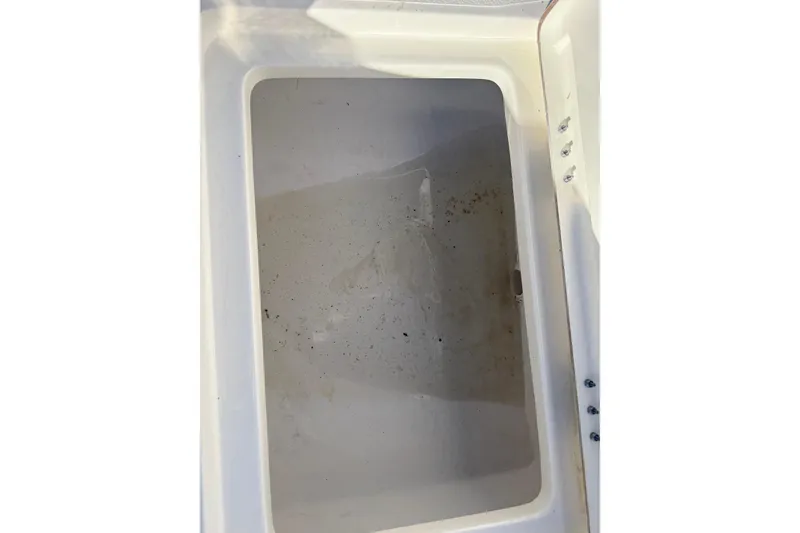 Slide: The Image of Empty storage compartment in 2025 Skeeter SX221 boat, showing interior details. - 33