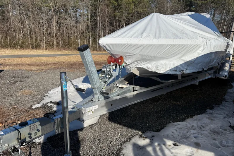 Slide: The Image of Covered 2025 Skeeter SX221 boat on trailer in outdoor setting. - 40