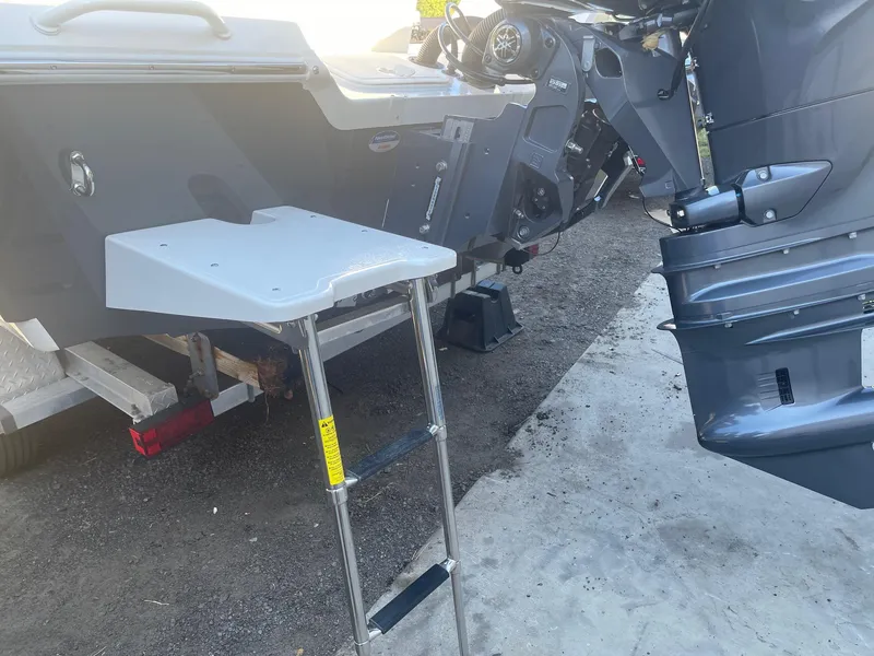 Slide: The Image of Livewell compartment on a 2025 Skeeter SX221 boat, open lid, white and blue interior. - 9