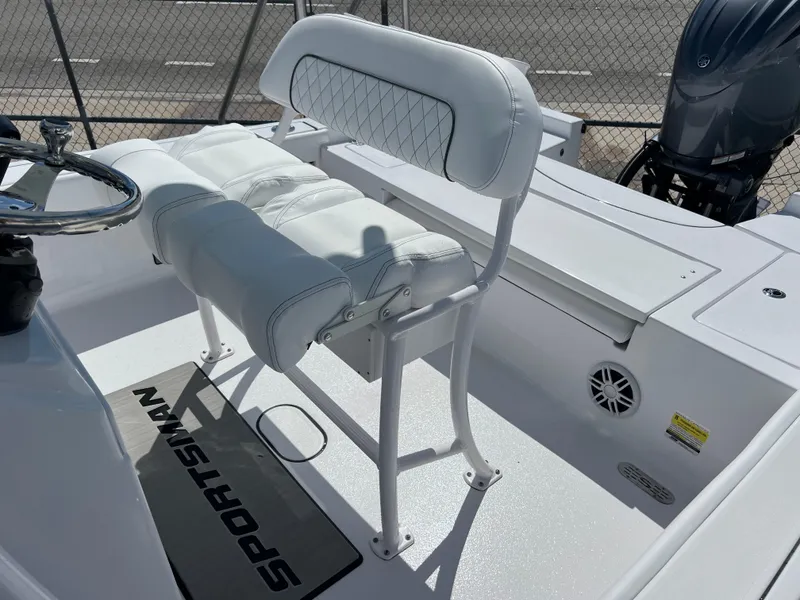 Slide: The Image of 2024 Sportsman Masters 227 Bay Boat interior with white seating and steering wheel. - 10