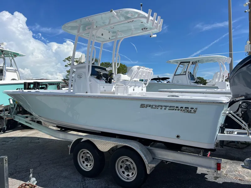 Slide: The Image of 2024 Sportsman Masters 227 Bay Boat on trailer under clear blue sky. - 14
