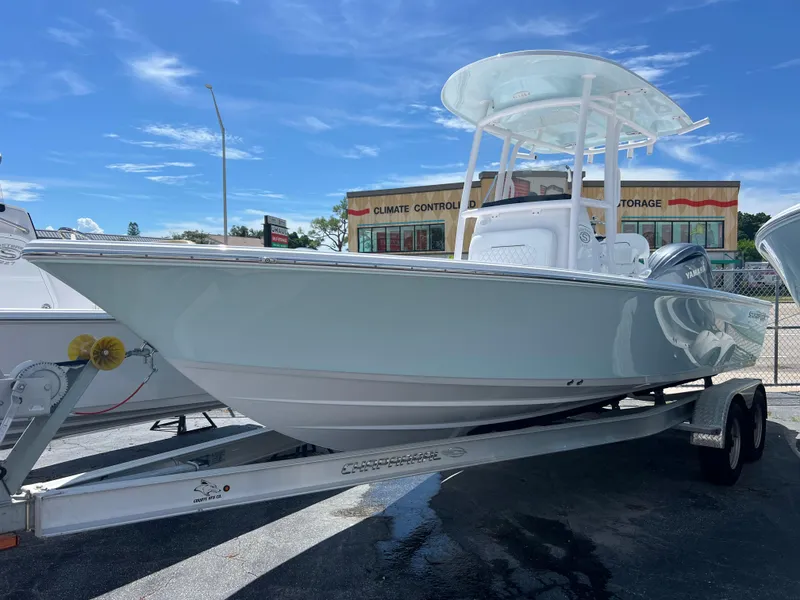 Slide: The Image of 2024 Sportsman Masters 227 Bay Boat on trailer, parked outdoors. - 2