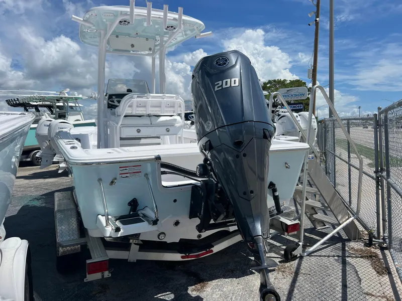 Slide: The Image of 2024 Sportsman Masters 227 Bay Boat with 200 HP engine, parked outdoors. - 3