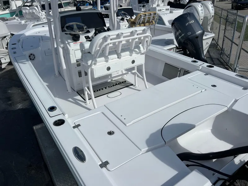 Slide: The Image of 2024 Sportsman Masters 227 Bay Boat with dual outboard motors, spacious deck, and modern controls. - 4