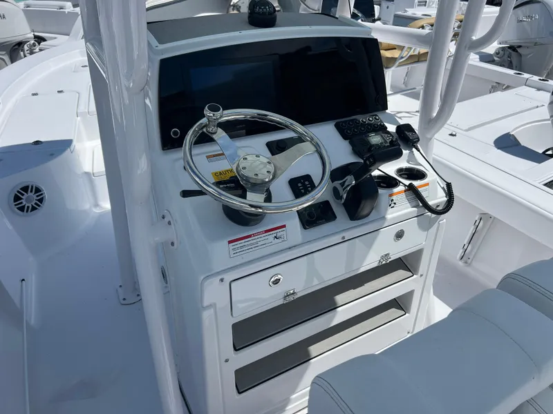 Slide: The Image of 2024 Sportsman Masters 227 Bay Boat console with steering wheel and controls. - 6