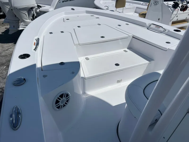 Slide: The Image of 2024 Sportsman Masters 227 Bay Boat deck with storage compartments and seating. - 8