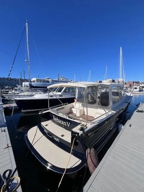 Slide: The Image of 2014 MJM 36z Downeast boat docked at marina under clear blue sky. - 11