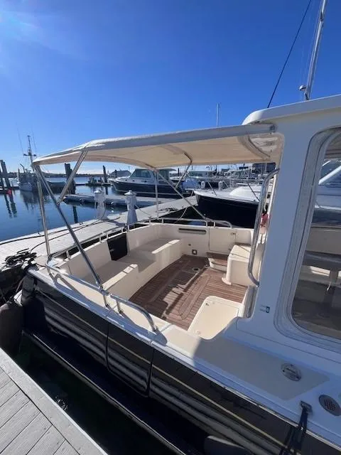 Slide: The Image of 2014 MJM 36z Downeast boat docked at marina under clear blue sky. - 12