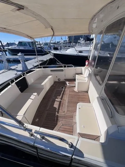 Slide: The Image of 2014 MJM 36z Downeast boat with spacious deck and seating at marina. - 14