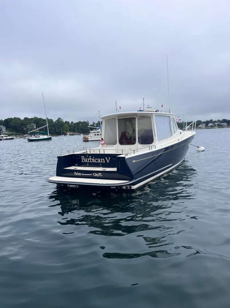 Slide: The Image of 2014 MJM 36z Downeast boat on calm water, overcast sky. - 16