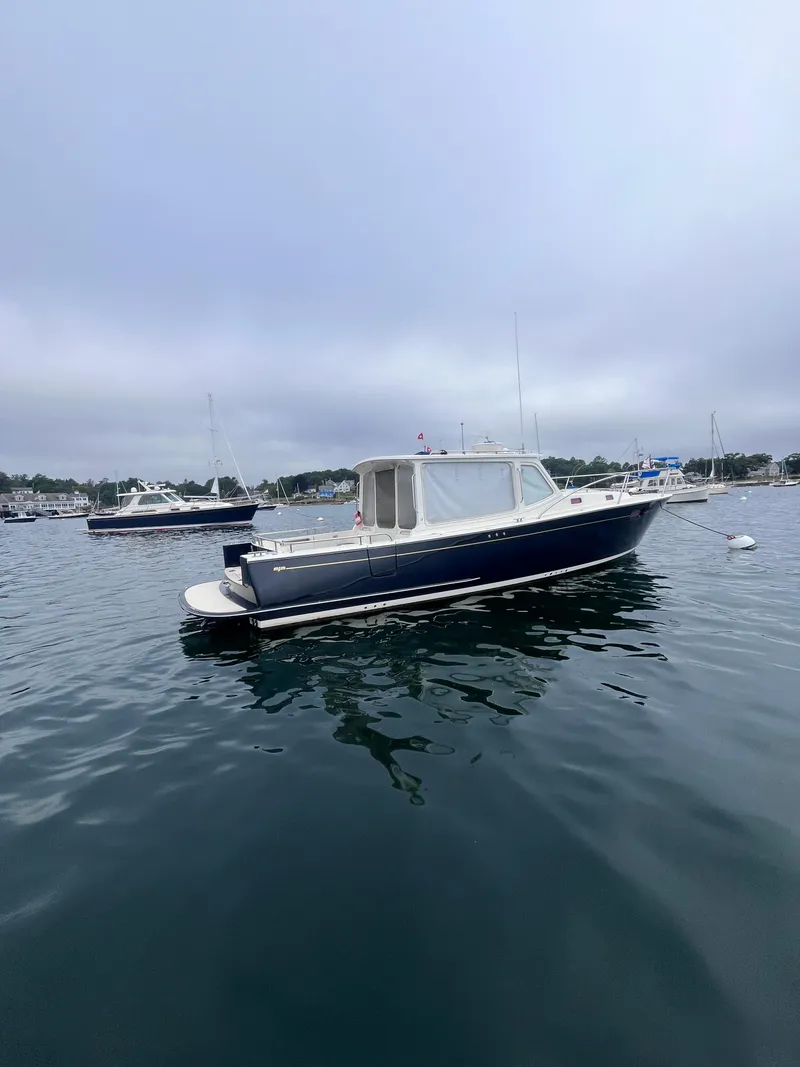 Slide: The Image of 2014 MJM 36z Downeast boat on calm water, overcast sky. - 17