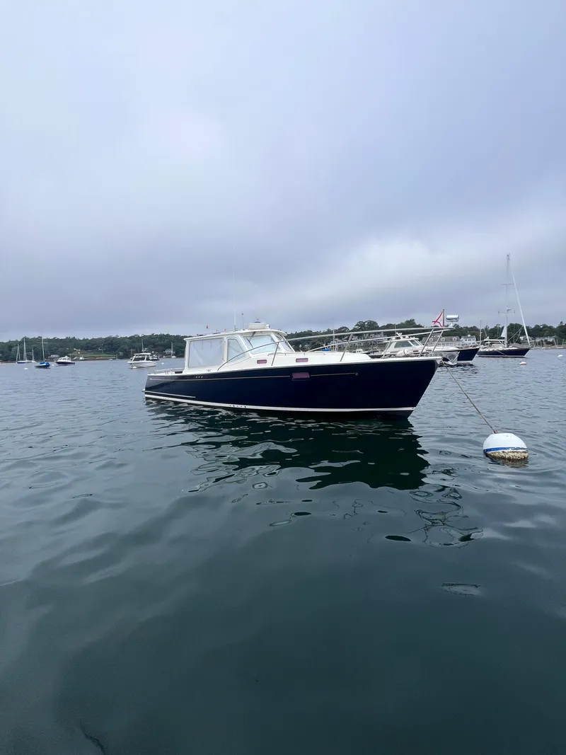 Slide: The Image of 2014 MJM 36z Downeast boat on calm water, overcast sky. - 18