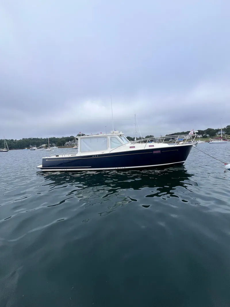 Slide: The Image of 2014 MJM 36z Downeast boat on calm water, overcast sky. - 19