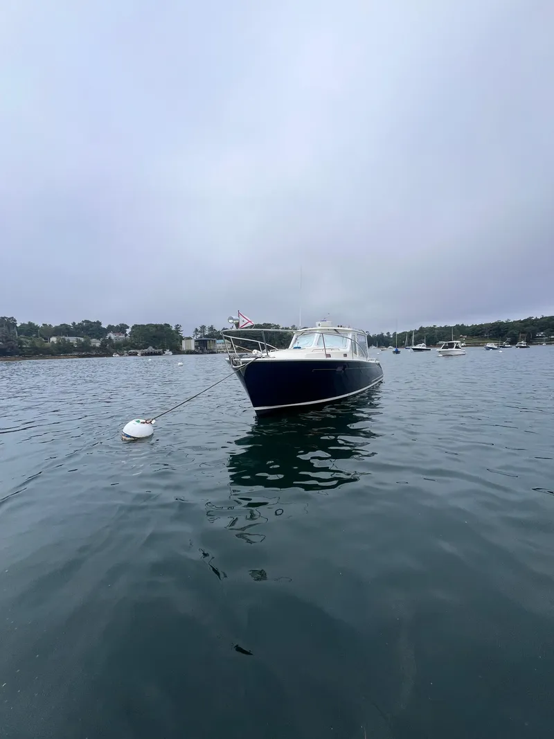 Slide: The Image of 2014 MJM 36z Downeast boat moored on calm water. - 22