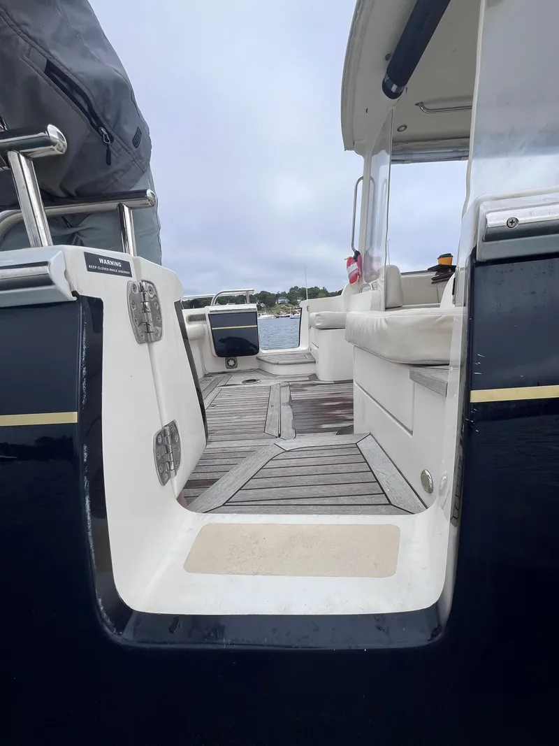 Slide: The Image of 2014 MJM 36z Downeast boat interior with wooden deck and seating. - 30