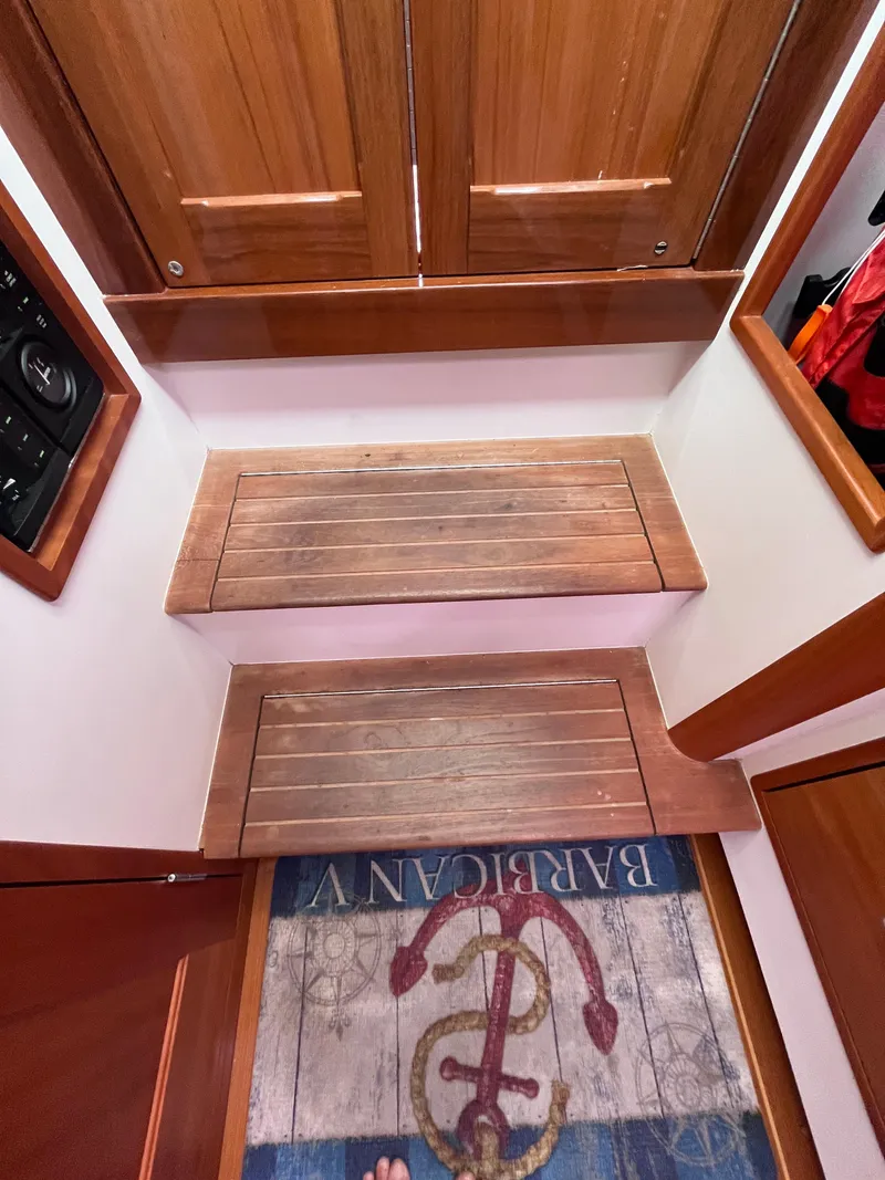 Slide: The Image of Wooden steps inside a 2014 MJM 36z Downeast boat with nautical-themed rug. - 43