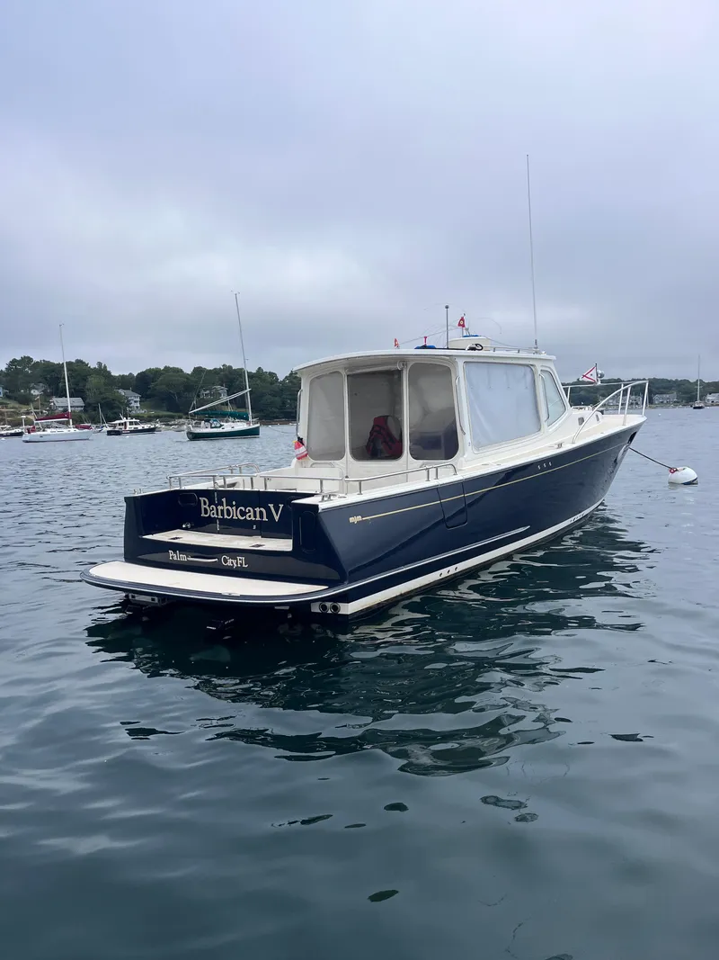 Slide: The Image of 2014 MJM 36z Downeast boat on calm water, overcast sky. - 6