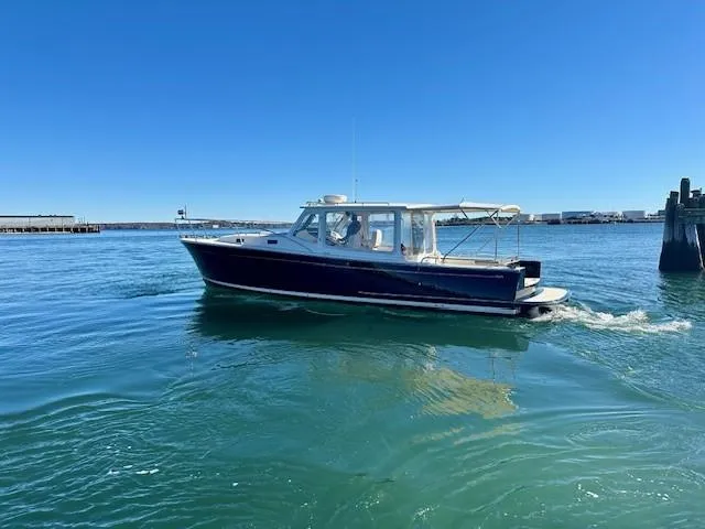Slide: The Image of 2014 MJM 36z Downeast boat cruising on clear blue water. - 7