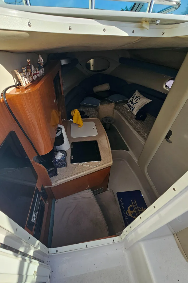 Slide: The Image of Interior cabin of 2002 Four Winns 248 Vista boat with seating and storage. - 10