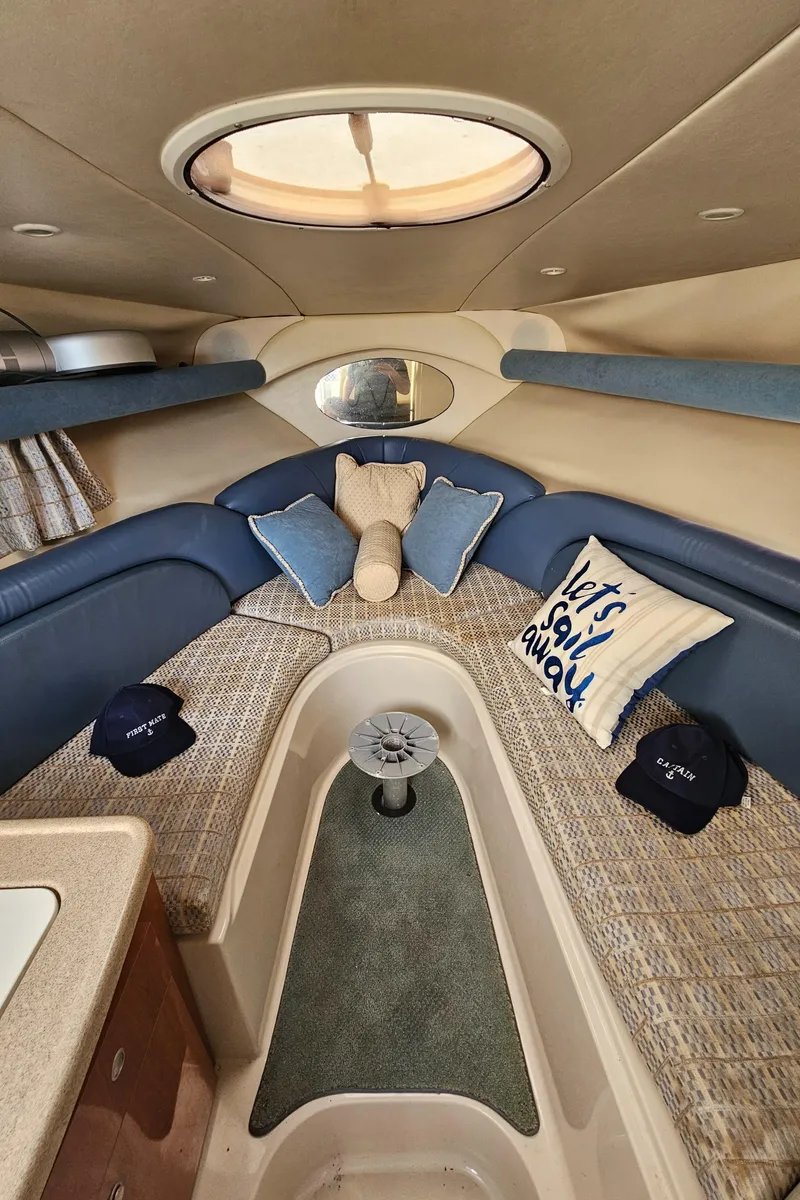 Slide: The Image of Interior of 2002 Four Winns 248 Vista boat with cozy seating and nautical decor. - 11